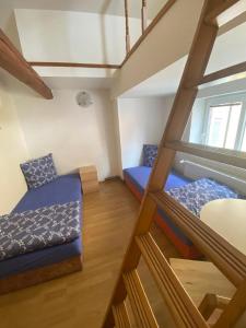 um quarto com 2 beliches e uma escada em Pension Hejnice em Hejnice