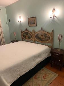 a bedroom with a large bed and two night stands at Casa Dos Pombais in Guimarães