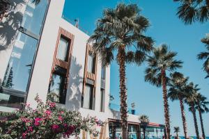 a building with palm trees in front of it at H Boutique Peña Parda in La Herradura