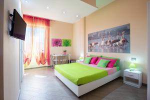 a bedroom with a green and pink bed and a television at A View on Cagliari in Cagliari +91 photos