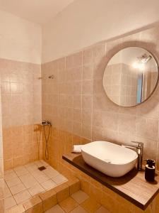 a bathroom with a large sink and a mirror at SunRise Apartment near Airport in Spata