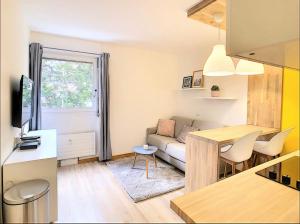 a small living room with a couch and a table at Centre Saint-Gervais studio Jaune moderne proche télécabine 2 pers in Saint-Gervais-les-Bains