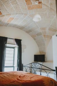 a bedroom with a bed and a brick ceiling at Le Camporelle In Città in Lecce
