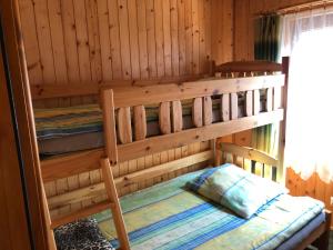 a bedroom with two bunk beds in a cabin at Domki Letniskowe in Jastarnia