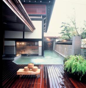 a swimming pool with a fireplace in a house at Kyotoya in Takeo