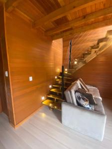 a staircase in a room with wooden walls at Chalé Guest House in Urubici