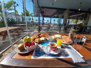 a table with a tray of breakfast food on it at H Boutique Peña Parda in La Herradura
