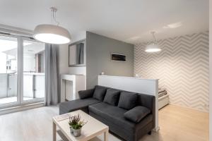 Televízia a/alebo spoločenská miestnosť v ubytovaní Waw Apartamenty Manhattan