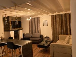 a living room with a couch and a table at Maison de charme in Pessac