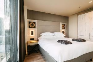 a bedroom with a large white bed and a window at Tallink City Hotel in Tallinn