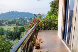 a balcony with plants and flowers on a building at Sky Edge Homestay in Kandy