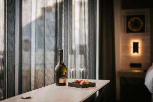 a bottle of wine and two wine glasses on a table at Tallink City Hotel in Tallinn