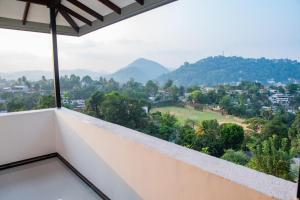 a balcony with a view of a city and mountains at Sky Edge Homestay in Kandy