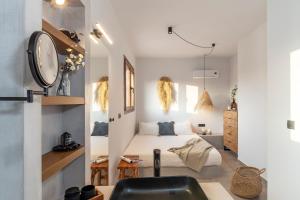 a bedroom with a bed and a sink in a room at Luxury NissoVilla with Private Pool & Sea Views in Kolimbia