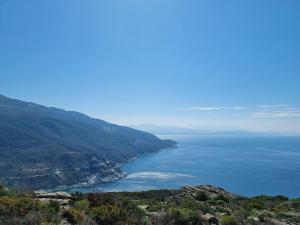 a view of the ocean from a mountain at LOCATION CORSE in Canari +16 photos