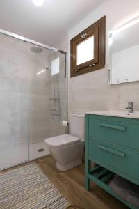 a bathroom with a toilet and a sink and a shower at Casa Alvar - Califa Casas Vejer in Vejer de la Frontera