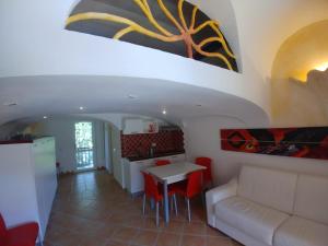 a living room with a white couch and a table at casa Valentina con piscina in Porto Rotondo