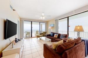 a living room with a couch and a flat screen tv at Romar Place 806 in Orange Beach