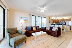 a living room with a couch and chairs and a table at Romar Place 806 in Orange Beach