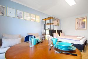 a dining room with a table with blue dishes on it at Eddy's Rest & Relax - Munich East in Munich +6 photos