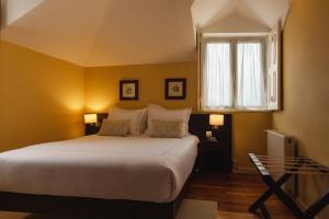 Ένα ή περισσότερα κρεβάτια σε δωμάτιο στο Glicínia Boutique Hotel