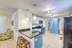 a kitchen with a counter and chairs in a room at PCB Group Retreat with Deck, 1 Block to Beach! in Panama City Beach