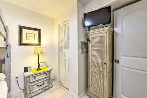 a bedroom with a television on top of a closet at PCB Group Retreat with Deck, 1 Block to Beach! in Panama City Beach
