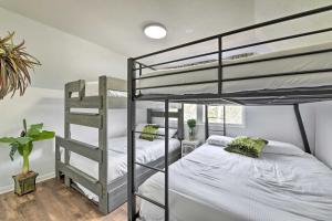 a bedroom with two bunk beds and a window at PCB Group Retreat with Deck, 1 Block to Beach! in Panama City Beach