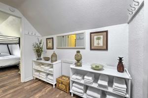 a bathroom with a sink and a bed in a room at PCB Group Retreat with Deck, 1 Block to Beach! in Panama City Beach