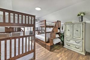 a room with two bunk beds and a dresser at PCB Group Retreat with Deck, 1 Block to Beach! in Panama City Beach