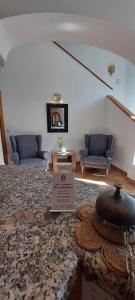 a living room with two couches and a sign on the floor at Hotel-Restaurant Kreuzhuber in Neuburg am Inn