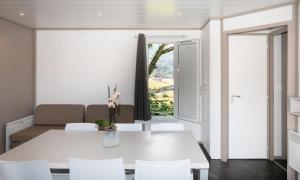 Saint-Martin-dʼArrossaDomaine Chalets Larlapean的白色的用餐室配有白色的桌椅