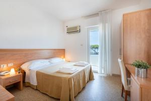 Łóżko lub łóżka w pokoju w obiekcie Hotel La Pineta