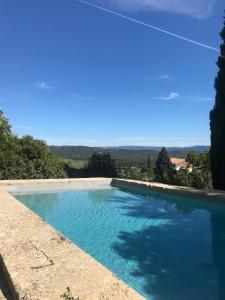 a large swimming pool with blue water at Le Clos des Merveilles in Rognes