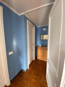 a hallway with blue walls and a brown floor at Aurea Bonassola in Bonassola