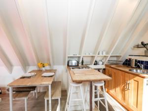 a kitchen with wooden counters and tables in a room at Blue Bell in Corsham