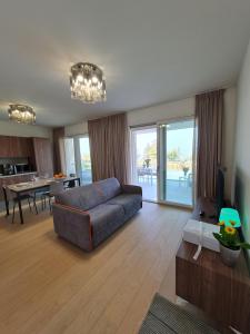 a living room with a couch and a dining room at SOLE DI DIANA LUXURY Apartments in Peschiera del Garda
