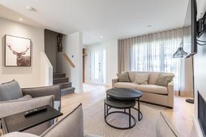 a living room with a couch and a table at Condos Kamik Tremblant in Mont-Tremblant