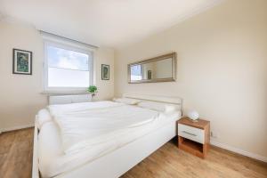 Ένα ή περισσότερα κρεβάτια σε δωμάτιο στο Luxus-Loft-Sylt Haus Dünenburg