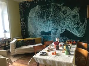 a living room with a table and a couch at Maison Mercredi in Piégut-Pluviers