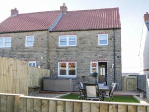 a house with a patio and a fence at Old Peak in Scarborough