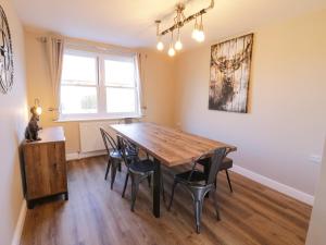 a dining room with a wooden table and chairs at Old Peak in Scarborough