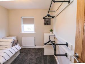 a small room with a bed and a window at Old Peak in Scarborough