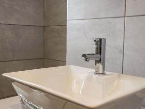 a sink with a faucet in a bathroom at Old Peak in Scarborough +38 photos