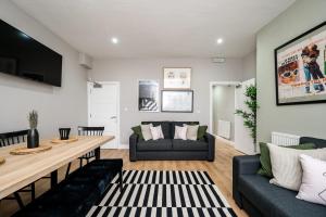 a living room with a table and a couch at Host & Stay - Stunning Georgian Multi-Unit Townhouse Apartment in Liverpool