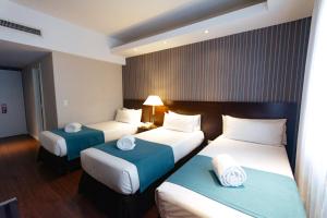 Una cama o camas en una habitación de Dorá Hotel Buenos Aires