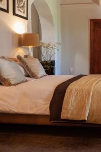 a bed with white sheets and pillows in a bedroom at Bloemendal Wine Estate Accommodation in Cape Town