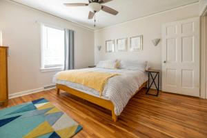 a bedroom with a bed and a ceiling fan at Waterfront Edenton Bay Cottage - Walk to Dtwn in Edenton