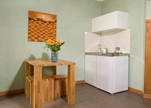 a kitchen with a table and a white refrigerator at Heidelberg ROOMS in Heidelberg