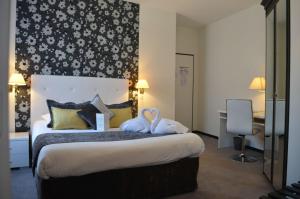 a hotel room with a bed with towels on it at Hotel de France Citotel in Rochefort